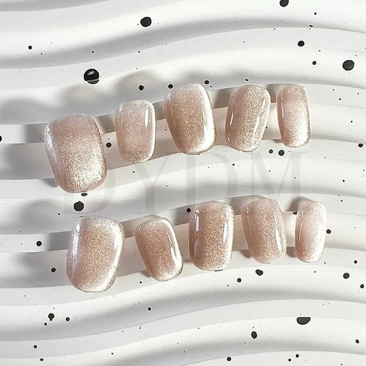 Champagne Lust Mesmerizing cat eye handmade press-on nails in a luxurious champagne hue, creating an enchanting play of light and shimmering allure